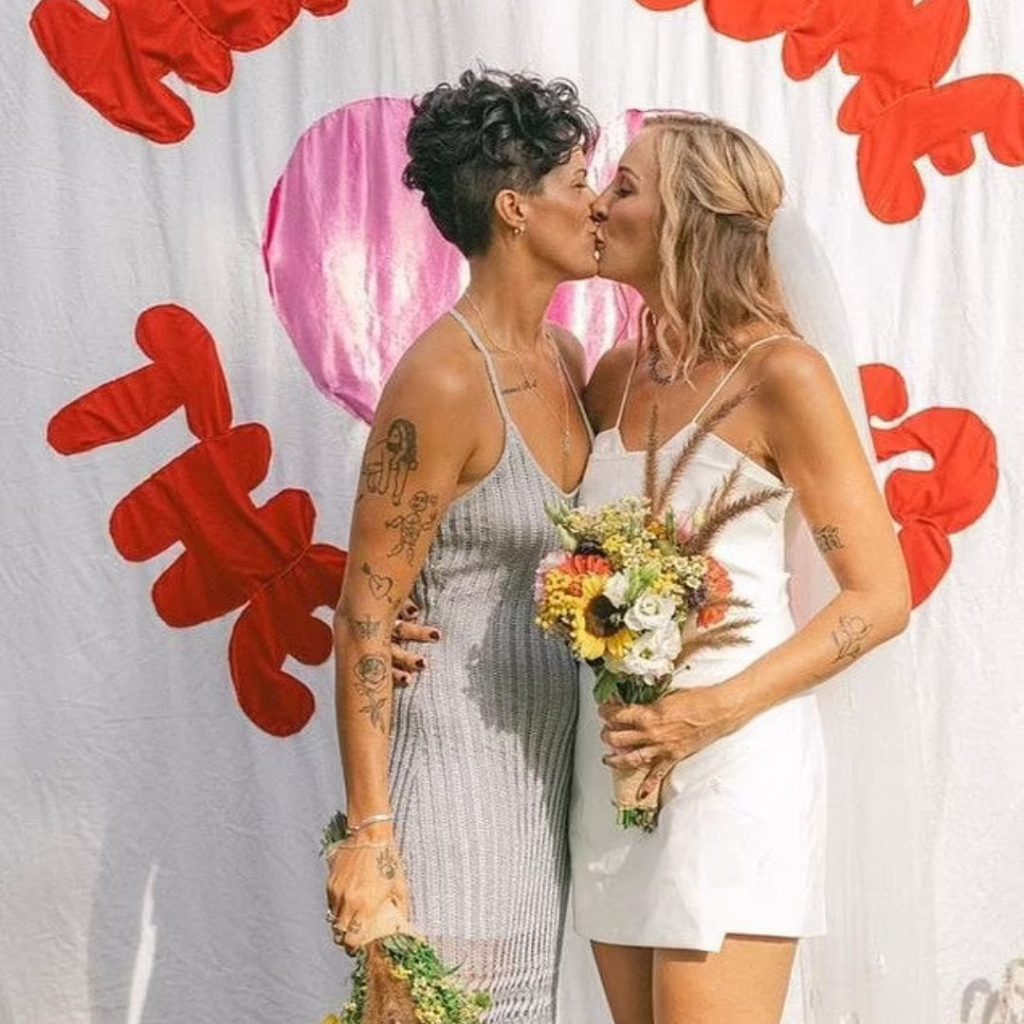 Two brides sharing a kiss